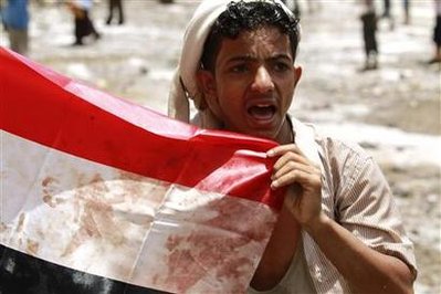 An anti-government protester holds a blood-stained ...